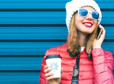 Woman with coffee on phone