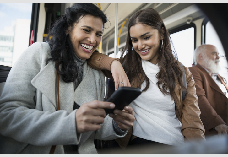 two women looking at phones