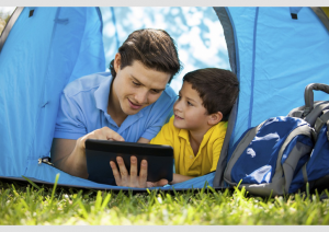Two people in tent using a tablet