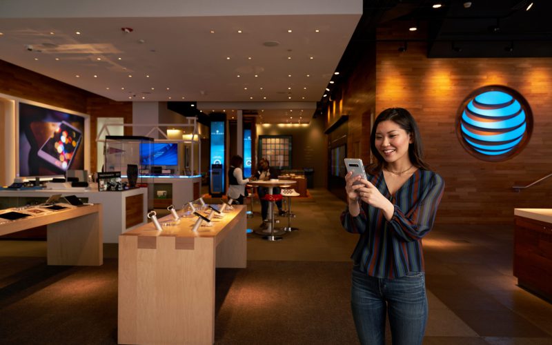 Woman with a phone at an AT&T store