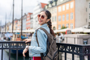 Asian young woman backpacker traveler traveling outdoors