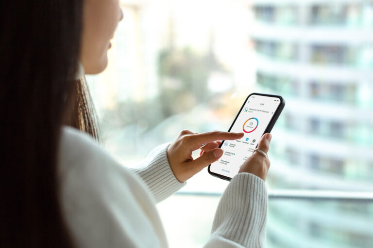 A woman uses ActiveArmor on her smartphone.