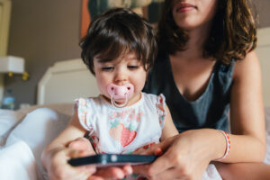 A woman and a child with a phone
