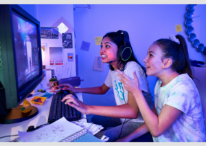 A picture of two tween girls using a computer and having fun.
