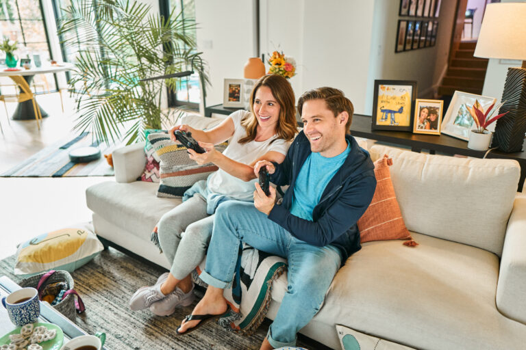 a picture of a couple playing video games