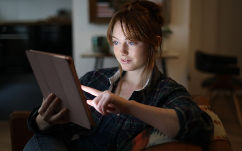 A picture of a woman using a tablet