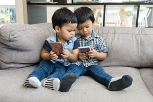 Young Asian boys play on smart phone