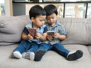 Young Asian boys play on smart phone