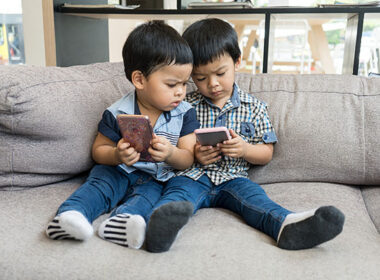 Young Asian boys play on smart phone