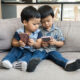 Young Asian boys play on smart phone