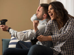 happy smiling couple playing video games at home.