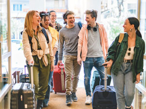 Group of university college tourist walking inside the hotel with luggage
