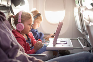 Adorable little boy girl travel by plane. Cute Kids sit at the w