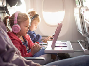 Adorable little boy girl travel by plane. Cute Kids sit at the w
