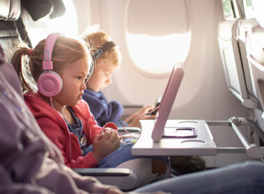 Adorable little boy girl travel by plane. Cute Kids sit at the w