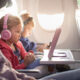 Adorable little boy girl travel by plane. Cute Kids sit at the w
