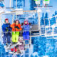 Three girls in colorful outfits sit on ski lift talking and smiling together lifting on top of the mountain