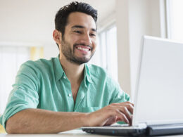 Young man working on laptop at home