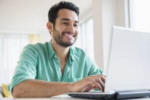 Young man working on laptop at home