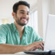 Young man working on laptop at home